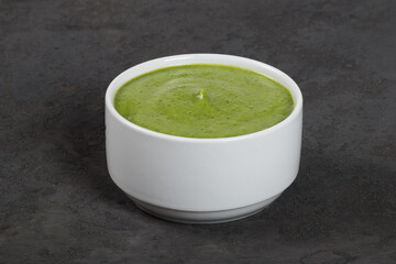 Pea soup puree. Dark grey background. Close up	