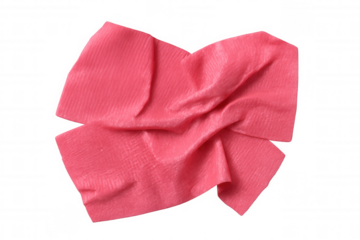 Crumpled pink chewing gum lying flat on transparent surface, highlighting soft folds and vivid candy-like coloration
