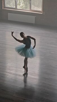 Graceful ballerina enjoys ballet choreography in studio