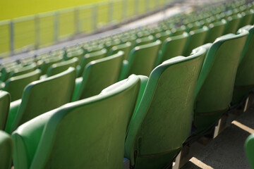 Fototapeta premium Empty green stadium seats in rows seating