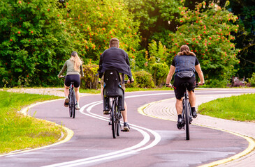 Obraz premium Cyclists ride on the bike path in the city Park 