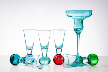 Transparent vodka glasses and one punch glass on white background, clean minimal still life, perfect for advertising barware, cocktail and beverage product photography, isolated on white