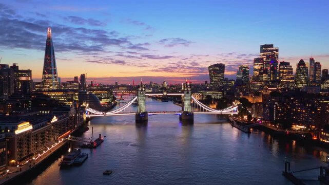 London Skyline Aerial Pullback Reveal of Tower Bridge and City Lights at Sunset