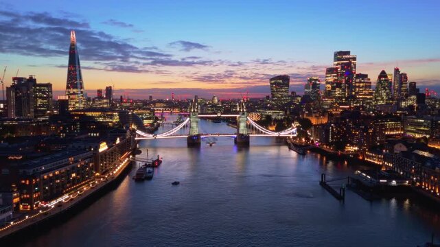 London Skyline Aerial Pullback Reveal of Tower Bridge and City Lights at Sunset