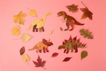 Leaf dinosaurs on pink background symbolizing eco creativity for kids education, nature branding, preschool materials, sustainable lifestyle, handmade art, and playful design