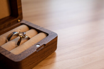 gold marriage rings wooden case detail