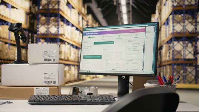 Empty distribution hub with big industrial storage racks filled with packages for large scale e-commerce operations. Space designed for fast delivery, product packaging and order processing.