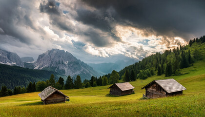 Obraz premium idyllic mountain landscape with wooden cabins and dramatic cloudy skies