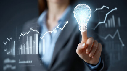 Innovative businesswoman touching glowing light bulb symbolizing ideas and creativity, with graphs and data analytics in background, representing growth and success