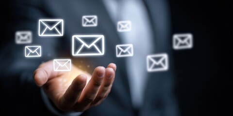 Businessman's hand displaying email icons