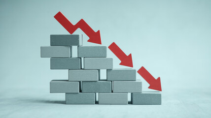 Stock market crash concept showing financial crisis with red arrow going down on brick wall graph
