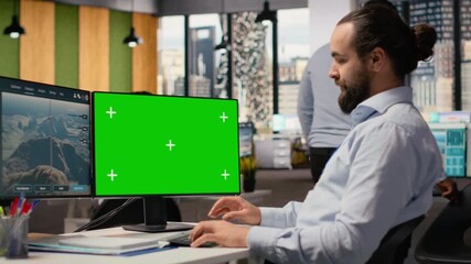 Worker uses green screen mockup PC to optimize advanced VAWT wind farm layout, enhancing clean energy production. Technician uses chroma key computer to do futuristic wind turbine simulation, camera B - Powered by Adobe