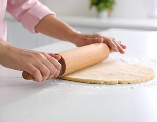 Woman rolling out dough on a kitchen counter