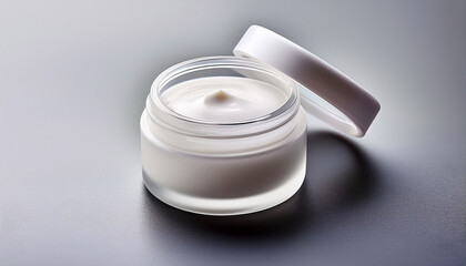 the jar of skin cream is small and white