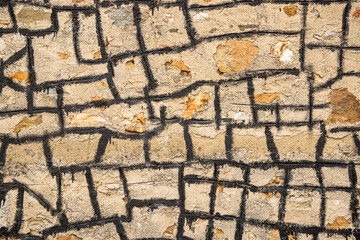 Masonary wall sealed with black tar.