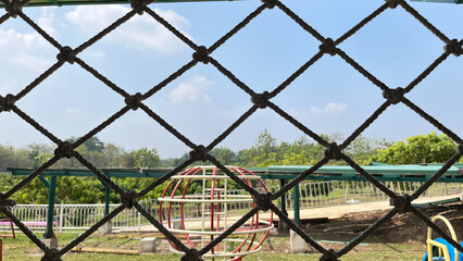 playground from behind an iron fence