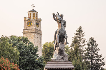 Obraz premium Clock tower and equestrian statue of King Philip of Macedonia.