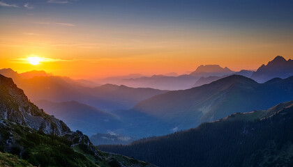 Obraz premium sunset over the mountains with orange and blue hues