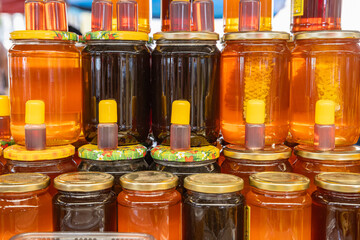Local honey for sale at an outdoor market.