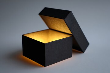 Open black gift box with inner light