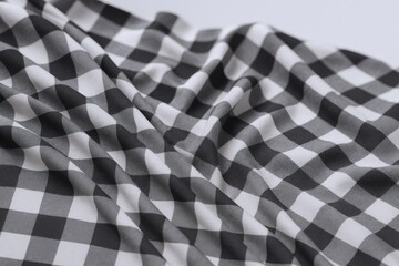 Fototapeta premium Close-up of Black and White Gingham Fabric with Soft Draping, Ideal for Textile and Fashion Backgrounds