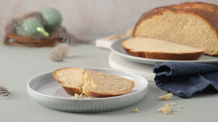 Traditional Portuguese folar slices on white plates amidst Easter decorations