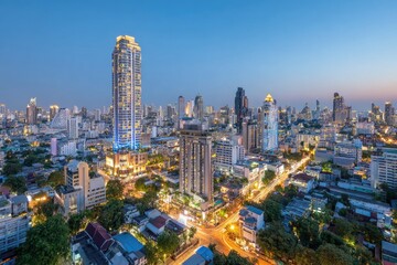 Fototapeta premium Aerial cityscape at twilight, vibrant city lights