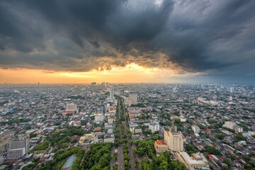 Fototapeta premium Aerial view of a city at sunset, storm clouds overhead