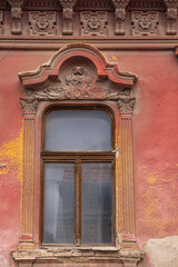 Windows in an old red building.