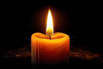 Single candle flame in dark (2)