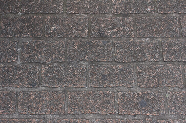 Texture of gray and beige square paving tile. Pattern of sidewalk tiles in the street. Concrete pavers close up background.