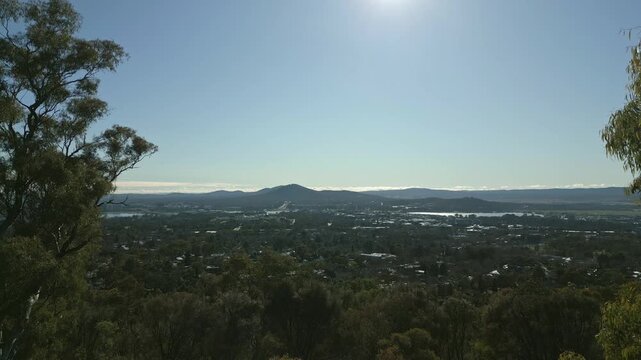 Moving between two trees to reveal the City of Canberra Australia,