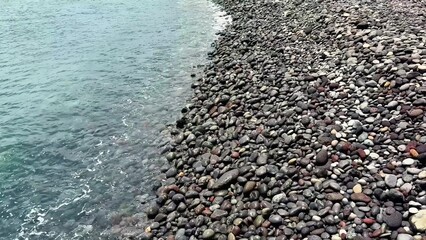 A stunning Rocky Beach with calm waves and clear water, ideal for relaxation and exploration
