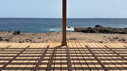 Enjoy the Serene and Beautiful Ocean View from a Comfortable Wooden Deck Overlooking the Sea