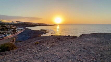 An absolutely stunning sunset view over the beautiful ocean along the rocky shoreline area