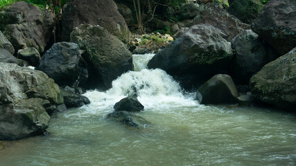 Cascading Water Over Rocks in a Serene Stream