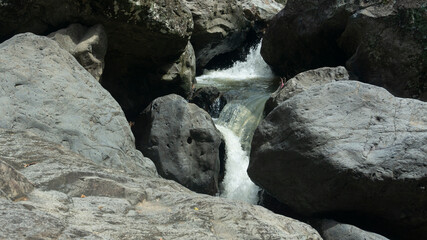Cascading Water Over Rocks in a Serene Stream