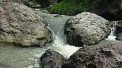 Cascading Water Over Rocks in a Serene Stream