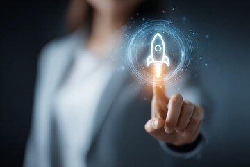 Businesswoman pointing at a holographic rocket launch icon