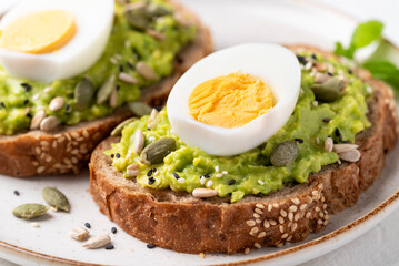 Avocado toast with boiled egg, sunflower seeds, pumpkin seeds and sesame seeds, Healthy eating
