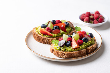 Avocado toast with strawberry, blueberry, raspberry and grape. Healthy eating