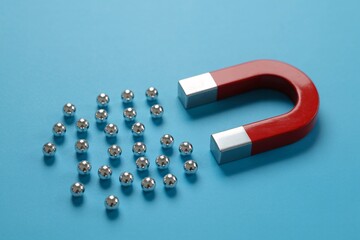 A red horseshoe magnet attracting metal spheres, symbolizing marketing, influence, and leadership.
