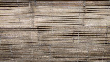 Close-up of weathered bamboo paneling showing horizontal lines and natural patina perfect for design backdrops, eco-themed visuals, or rustic texture overlays.
