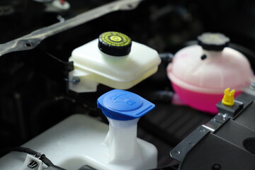 windshield washer fluid reservoir cap in engine room.	