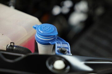 windshield washer fluid reservoir cap in engine room.	
