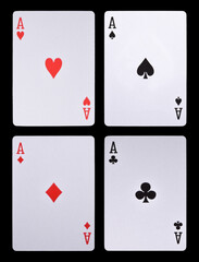 Set of four aces playing cards suits isolated on black background