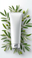 White cosmetic tube surrounded by olive branches and olives