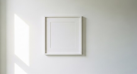 Blank frame on wall with sunbeam