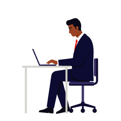 A dark-skinned businessman in a suit sits at a desk, typing on a laptop computer, focused on his work.