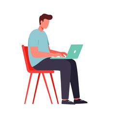 A faceless man sits on a red chair and works on a laptop with a green screen, focused on his task.